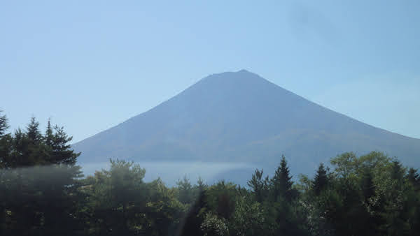 mount fuji in the distance from the bus